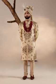 Frosted Almond Sherwani Set | Jatin Malik Introducing our masterpiece: the golden placement hand-embroidered sherwani. This exquisite sherwani showcases an intricate embroidery technique that utilizes various types of dabka and moti, creating a stunning visual impact. Paired with a wine hand-embroidered stole and matching safa, this ensemble epitomizes refined luxury and traditional excellence. Perfect for making a grand and elegant statement, this sherwani set is a testament to exceptional craftsmanship and timeless style. Included in purchase: Sherwani, Kurta, Churidar, Stole, Safa Product Specification Color: Golden Fabric: Linen silk Occasion: Engagement, Wedding, Bridal, Reception Style: Sherwani, Kurta, Churidar, Stole, Safa Care: Dry Clean Work: Hand Embroidery Customization options Reception Bandhgala With Zari Work, Naqshi Embroidered Straight Sherwani For Reception, Naqshi Embroidered Sherwani For Reception, Naqshi Embroidered Straight Kurta Sherwani For Reception, Unstitched Sherwani For Reception, Traditional Jamawar Churidar With Naqshi Detailing, Jamawar Churidar With Naqshi And Traditional Drape, Sherwani For Reception With Resham Embroidery And Straight Kurta, Traditional Churidar With Gold Embroidery For Designer Wear