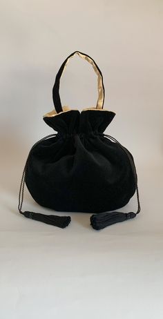 This elegant black velvet pouch bag is perfect as an evening bag and could also be used as casual bag  in both formal and informal occasions.  Dimensions:    Width 27 cm x Height 27cm  ( inside length when closed approx 20cm ).  Strap length approx: 38 cm including clasps The  black velvet fabric of this bag is lightweight and super soft. The lining is a medium weight buttermilk coloured satin, silky soft, the handmade drawstrings and  tassels are a soft black cotton decorated with black acrylic Credit Card Pouch, Embroidered Clutch Bag, Japanese Knot Bag, Black Velvet Fabric, Black Evening Bag, Vintage Evening Bags, Wristlet Bag, Embroidered Clutch, Card Pouch