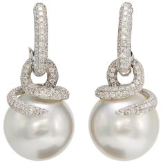 18K White Gold drop earrings featuring two South Sea Pearls measuring 14-15 mm flanked with numerous diamonds weighing 1.55 carats. Comes in Rose Gold White Gold Drop Earrings, Earrings Multiple, South Sea Pearls Earrings, Gold Chandelier Earrings, Black Earrings Dangle, Pearl And Diamond Earrings, Diamond Dangle Earrings, Earrings Diamond, Sea Pearl