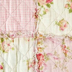 the pink and white quilt has roses on it