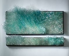 two pieces of art that look like they are made out of metal and glass with green paint on them