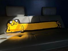 a couch with a pillow that looks like a cartoon character