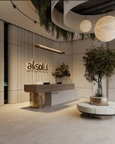 an office lobby with two planters and a reception table in the center, surrounded by hanging plants