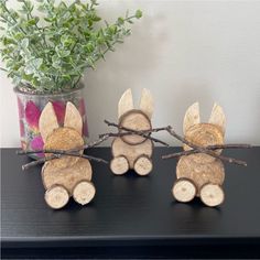 three pieces of wood that have been made to look like turkeys on sticks and are sitting on a table