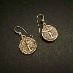 "Handmade antiqued bronze coin charms with the zodiac sign of Libra birthday gift for people born between Sept 23 - Oct 23. Libra are: Cooperative, Diplomatic, Gracious, Fair-minded, Social On those dainty earrings an angel is in the middle overlooking the scale. The concept of the zodiac originated in Babylonian astrology, and was later influenced by Hellenistic culture. According to astrology, celestial phenomena relate to human activity on the principle of \"as above, so below\", so that the Libra Birthday, As Above So Below, Tarpon Springs, Cameo Jewelry, Human Activity, September 23, October 23, Dainty Earrings, Antique Bronze