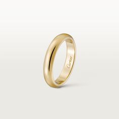 a yellow gold wedding ring with the word love engraved on it's outside side