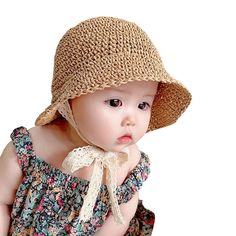 a small child wearing a hat and dress