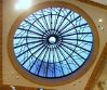 the inside of a building with a large circular glass window in it's center