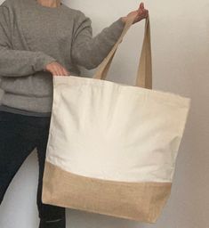 This Extra large holdall / shopper tote / beach bag is perfect to complete all relaxed, BoHo looks. Sturdy yet stylish, you will want to take it everywhere! █ SIZE: CM 56 x 44 x 17 (INCHES 22 x 17.5 x 7). █ the HANDLES measure CM 63 (INCHES 25). █ Made of natural cotton with a jute base. █ Gorgeously natural oatmeal colour █ READY TO SHIP - I use ROYAL MAIL secure services and provide a tracking number after shipping. █ TYPICAL DELIVERY TIMES: EUROPE: 4 to 7 days NORTH AMERICA and RUSSIA: 6 to 1 Eco-friendly Large Canvas Beach Bag, Large Capacity Natural Cotton Beach Bag, Eco-friendly Large Capacity Beige Canvas Bag, Eco-friendly Large Capacity Cotton Beach Bag, Eco-friendly Beige Canvas Bag With Large Capacity, Eco-friendly Large Capacity Natural Canvas Bag, Eco-friendly Large Canvas Bag In Natural Color, Large Capacity White Jute Beach Bag, White Large Capacity Jute Beach Bag