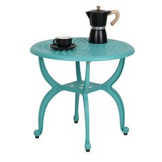 a blue table with a coffee pot on it and a cup sitting on the top