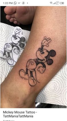 a person with a mickey mouse tattoo on their arm and leg, sitting next to each other