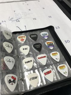 a case filled with lots of different types of guitar picks on top of a table