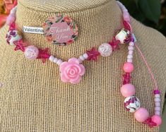 This beautiful pink beaded necklace set is perfect for adding a touch of girly glam to any outfit. The set includes a long necklace with a variety of pink beads, including pink glass beads, pink acrylic beads, and pink seed beads. A sparkling pink star charm and a delicate rose charm add a touch of whimsy to the design. The necklace is finished with a lobster clasp closure. The set also includes a shorter necklace with pink beads and a magnetic clasp closure. Adjustable Single Strand Pink Beaded Necklace, Pink Single Strand Bohemian Beaded Necklaces, Pink Bohemian Single Strand Beaded Necklaces, Bohemian Pink Single Strand Beaded Necklaces, Feminine Adjustable Beaded Necklaces, Adjustable Feminine Beaded Necklaces, Adjustable Feminine Beaded Necklace, Pink Beaded Chain Jewelry For Gift, Cute Pink Beaded Chain Jewelry