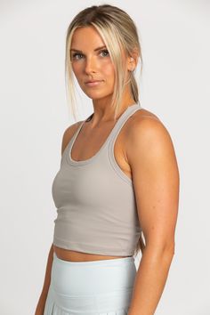 Our Sandstone Racerback Crop Tank features a slight cropped fit and racerback style that is the perfect go-to athletic top. It is complete with sweat-wicking material and a double layer, built-in-removable padded bra. Pleated Tennis Skirt, Tennis Skirts, Athletic Top, Padded Bra, Yoga Tops, Tennis Skirt, Clothes And Shoes, Crop Tank, Bra Tops