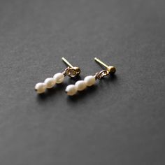 When the occasion calls for a little something extra, our mini Pearl Earrings are the perfect fit. These lightweight earrings are a striking drop style with freshwater pearls.A classic piece of timeless jewelry, these would be the perfect gift for a bride or bridesmaid Details: Size: .75” ling Earring post material: 14k gold fill (100x more real gold than plated materials), perfect for those with sensitivities All profits from the sale of our ethically made jewelery are donated to charity, you c Dainty Pearl White Earrings For Pierced Ears, Delicate Pearl Hypoallergenic Earrings, Dainty Pearl White Earrings, Minimalist Pearl Pendant Earrings For Anniversary, Delicate Pearl White Earrings With Pearl Charm, Dainty Pearl Earrings For Pierced Ears, Delicate Pearl White Pearl Drop Earrings, Dainty Drop Pearl Earrings, Dainty White Pearl Drop Bridal Earrings