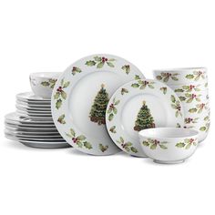 christmas tree dinnerware set with holly and berries on the rims, white background