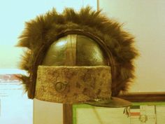 an old helmet is on display in a museum