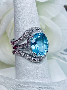 Blue Aquamarine Diamond Cut Rings, Sapphire Rings With Diamond Accents And Aquamarine, Blue Rings With Diamond Accents For Anniversary, Aquamarine Rings With Sapphire Color And Diamond Accents, Blue Oval Diamond Ring With Gemstone Accents, Blue Diamond Ring With Gemstone Accents, Oval Shape, Blue Oval Stackable Rings For Anniversary, Blue Aquamarine Ring For Anniversary, Elegant Blue Oval Stackable Rings