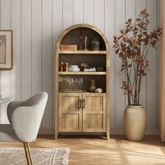 a living room with a chair, table and shelves