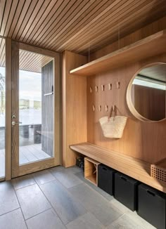 a wooden bench sitting under a mirror in a room