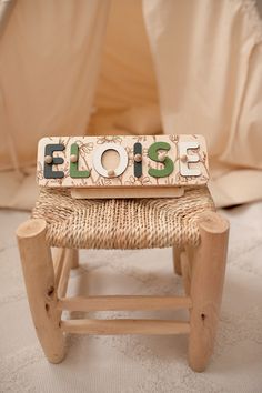 a close up of a small wooden chair with a sign on it that says, please