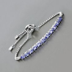 Tanzanite Bracelet, Genuine Tanzanite Bracelet Sterling Silver, Tanzanite Ovals Bolo Bracelet Silver, December Birthstone Bracelet Wear a beauty on your wrist with this 2.40 ct. t.w. tanzanite stylish bracelet. Fabulously affordable and full of color, it appeals to the eye and calls to the heart with its genuine oval tanzanite gemstones set in rhodium plated .925 sterling silver. Tanzanite stylish bracelet for women. Product Details:  .925 Sterling Silver Stone Details: Tanzanite Gross Wt: 7.71 Adjustable Oval Fine Jewelry Bracelet, Fine Jewelry Bracelets With Stones, Adjustable Fine Jewelry Bracelets With Stones, Adjustable Oval Sterling Silver Bracelet For Anniversary, Adjustable Oval Bracelet With Stones, Adjustable Oval Bracelets With Stones, Tanzanite Bracelet, 11 Stone, Blue Topaz Jewelry