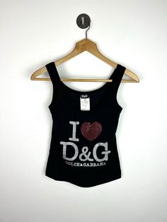 For sale is iconic Y2k Vintage Dolce & Gabbana womens 'I Love D&G' vest Made in italy, Soft stretchy fabric - Made in a 85% cotton/ 15% elastane mix Tagged size Small Measures 14'' Pit to pit across chest - Very stretchy to wear fitted, stretches to around 20'' across  20.5'' Length on back Good vintage condition, gently worn - some very minor cracking on the graphic as shown, study images. Shipped safely and securely  See my 100% positive feedback ! Runway Outfits, Vest Outfits, Dolce & Gabbana, Y2k Vintage, Womens Vest, Halloween Shopping, Labour Day, Vintage Ladies, Dolce And Gabbana