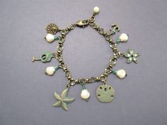 a bracelet with charms and seashells on it