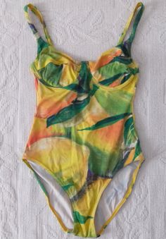 Vintage fruity and leafy pattern swimsuit. Flexible material in vivid summer colors. Before ordering the product, please read the product dimensions, as they may differ from the information on the label. Measurements taken from seam to seam while the garment is lying flat. Please, note that displayed on the monitor colors may vary from the actual, depending on individual monitor settings. PIT-PIT: 31 cm LENGTH without straps: 46 cm LENGTH with straps: 62 cm Summer Leaf Print Swimwear For Vacation, Fitted Orange Tropical Print Swimwear, Green Leaf Print Beachwear Swimwear, Green Tropical Swimwear With Leaf Print, Leaf Print Beachwear Swimwear For Pool, Leaf Print Swimwear For Beach Season, Summer Leaf Print Swimwear For Beach Season, Vibrant Tropical Print Swimwear For Summer, Vibrant Green Swimwear For Sunbathing