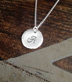 "Sterling Silver Initial Necklace Initial Charm Necklace Initial Necklace Monogram Necklace Bridesmaid Gift Gift for Mom Handstamped Necklace This Handstamped Sterling Silver Initial Necklace will make a great gift to any woman in your life. This listing includes: *One Sterling Silver Disc(18mm 22 gauge) with hammered edge stamped with the letter of your choice *One 18\" Sterling Silver Curb Chain * All components are .925 Sterling Silver Samples shown are stamped in 6mm Monogram at check-out, p Silver Monogram Pendant Charm Necklace, Silver Initial Pendant Necklace As A Gift, Silver Pendant Name Necklace For Gifting, Silver Pendant Name Necklace For Gifts, Silver Pendant Name Necklace As Gift, Hand Stamped Round Disc Jewelry For Anniversary, Personalized Silver Round Disc Jewelry, Stamped Sterling Silver Jewelry As Gift, Silver Monogram Nameplate Necklace