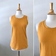 Basic cotton knit tank top.  This is a nice basic tank top that can be worn alone or layered. Length from shoulder to hem is about 25”  *Length can be adjusted for you as neededColor shown is Mustard Garments are Made To Order Please allow 7-10 days for your item to be sewnBelow are my standard size measurements, which are simply a guideline, if you would like to include your personal measurements in the notes to seller box during checkout, I will be sure to make you the best fit ~ if you have a Basic Stretch Vest Top, Layering Sleeveless Blouse In Any Color, Summer Cotton Vest With Scoop Neck, Sleeveless Blouse Tops For Layering, Casual Camisole Top For Layering, Sleeveless Blouse For Layering, Casual Camisole Tops For Everyday, Casual Everyday Camisole Tops, Casual Cotton Tank Top Sleeveless Blouse