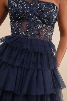 Flourish on the dancefloor all night long in the Lulus Fanciful Charm Navy Mesh Beaded Tiered One-Shoulder Mini Dress! This adorable dress falls from a single wide strap into a one-shoulder neckline and a corset-style bodice with lined cups and supportive boning, all composed of sheer mesh knit that boasts shiny sequins and a beaded design with floral applique details. High, fitted waist sits atop an A-line tulle skirt with fluffy tiers and a cute mini hem. Hidden back zipper/clasp. Fit: This ga Bustier Mini Dress, Sheer Clothing, Single Wide, Corset Style, Floral Applique, Sheer Dress, Mesh Dress, Tulle Dress, Fall Dresses