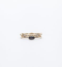 two gold rings with black and white diamonds