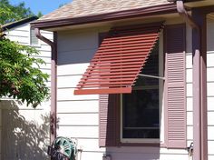 a red awning on the side of a house