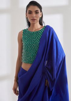 Color block your outfit with the chandelier top which is hand embroidered over a span of 8 days. The masai godet sari is pre draped and has a built in petticoat. Fusion Style Silk Pre-draped Saree With Traditional Drape, Fusion Style Silk Pre-draped Saree, Georgette Tops With Traditional Drape And Dupatta, Traditional Drape Silk Blouse Piece With Mirror Work, Traditional Drape Blouse With Mirror Work In Tissue Silk, Reception Blouse In Chanderi With Traditional Drape, Silk Fusion Blouse Piece With Traditional Drape, Reception Tops With Traditional Drape And Mirror Work, Fusion Style Silk Saree With Dupatta