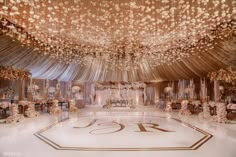 an elaborately decorated ballroom with white and gold decor