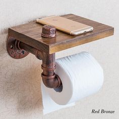 a toilet paper holder is attached to the wall with an old - fashioned wooden handle