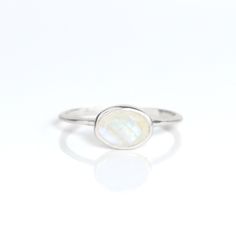 You'll fall in love with an iridescence of this Rainbow Moonstone ring. This is a perfectly sized oval to compliment any collection. Popular as a birthday gift for those June babes and Rainbow Moonstone lovers alike. This stone is beautifully faceted and bezel set in a 925 sterling silver band or plated with 18k vermeil gold. Gemstone is approximately 8 x 6mm.Band has 925 stamp on inside.Please note that each ring is handmade and there may be some slight variations from listing photo.Available i Sterling Silver Oval Moonstone Birthstone Ring, Oval Moonstone Birthstone Ring In Sterling Silver, Minimalist Oval Opal Ring For Gift, Minimalist Oval Opal Ring Gift, Oval Moonstone Birthstone Ring Gift, White Oval Moonstone Birthstone Ring, Oval Moonstone Gemstone Ring, Oval White Moonstone Birthstone Ring, Minimalist Oval Moonstone Birthstone Ring