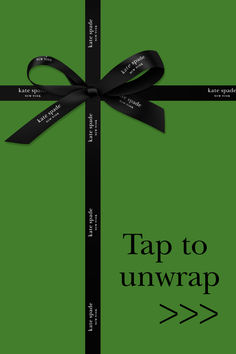 a green gift box with a black ribbon and tag that says tap to unwrap