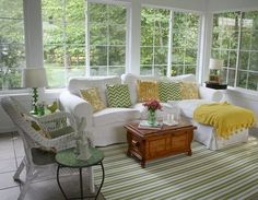 a living room filled with furniture and lots of windows