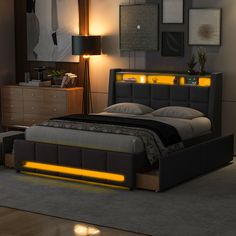 a bed that has some lights on the headboard and night stands in front of it