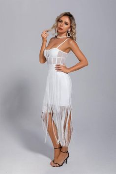 Going to a friend's party on the weekend and don't know what to wear? Then try our Ellie White Slip Tassel Party Dress! The pure white and luxurious exquisite design makes your temperament more noble and elegant, and can instantly dazzle in the crowd. The mesh at the waist is see-through, which can reveal a small waist. The flowing fringe on the skirt makes you walk like a fairy who has fallen into the mortal world. Pair it with a classic black leather pouch and a pair of stiletto heels for unde White Sleeveless Party Dress, Sleeveless White Dress For Party, Sleeveless White Party Dress, Summer Fringe Prom Dress, Summer Prom Mini Dress With Fringe, White Fitted Midi Dress For Prom, White Mini Dress For Prom And Party Season, White Midi Dress For Party Season, Elegant Fringe Party Dress