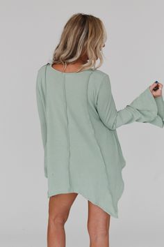 Step into the enchanting Golden Hour Long Bell Sleeve Top and embrace the boho vibes! Whether you're strolling through a festival or enjoying a casual day out, this top will add a touch of bohemian magic to your outfit because it features: Comfortable mini ribbed knit fabric Relaxed and loose silhouette for effortless style Flattering v - neckline Loose long bell sleeves for a whimsical look Exposed seams throughout create a unique boho aesthetic Cute uneven bottom edge detail adds an extra touc Spring V-neck Tunic For Loungewear, Bohemian Cotton Tops For Loungewear, Green V-neck Tunic For Fall, Casual Tunic Tops For Fall, Oversized V-neck Bohemian Top, Oversized Bohemian V-neck Top, Oversized Hippie Tops For Fall, Spring Bohemian Loungewear Tops, Bohemian Relaxed Fit Top For Loungewear