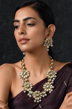 Gold Plated Kundan Inspired Necklace with Earrings Necklace Size - 22 inches. Closure - Dori Earrings size- 4.5 cm Closure- Pushback. Style Tip - Wear this with your choicest of summer fashion and chiffon sarees. We love teaming this with solid whites and bold blacks.Indian baratis who don't want to go overboard with red, this is a perfect solution to your pastel wedding dresses and floral gowns. A perfect companion for pastel lehengas and Indian wedding dresses. Handcrafted in Jammu and Kashmir Temple Jewelry Gota Work Necklace For Diwali, Diwali Temple Jewelry Necklace With Gota Work, Kundan Jewelry With Gota Work For Puja, Chandbali Necklace With Gota Work For Puja, Chandbali Gota Work Necklace For Puja, Diwali Jewelry For Puja With Gota Work, Diwali Puja Jewelry With Gota Work, Temple Jewelry With Mirror Work For Puja, Gold Kundan Necklace With Mirror Work For Puja