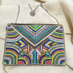 "Modern Marrakesh Bohemian Seed Beaded Clutch Bag Crossbody Handbag * Beaded Bag * Standard Bag Size: 11\" L X 8\" W  * Chain Strap: 48\" Detachable * 100% Cotton * One Inside Slip Pocket * Reinforced Magnetic Snap Closure" Multicolor Embellished Shoulder Bag For Everyday, Multicolor Rectangular Shoulder Bag With Colorful Beads, Multicolor Beaded Crossbody Shoulder Bag, Embellished Multicolor Shoulder Bag, Multicolor Beaded Handheld Shoulder Bag, Multicolor Rectangular Bag With Colorful Beads, Embellished Multicolor Pouch Shoulder Bag, Multicolor Beaded Pouch Bag, Bohemian Beaded Clutch For Festivals