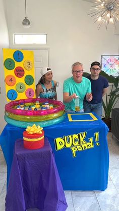 a group of people standing around a table