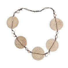 This lightweight statement necklace elegantly combines the luminous beauty of freshwater pearls with the earthy beauty of hand woven rattan. A double strand of waxed cotton knots 12 pearls in place. A piece of organic luxury that will elevate any ensemble. The magnetic closure makes it a snap to put on and remove. The rattan circles are about 1.75". The length of the necklace open is 21". If you would like a shorter version, just leave a note. Add this to your vacation wardrobe today! Adjustable Multi-strand Hand Wrapped Necklace, Adjustable Round Nature-inspired Necklace, Adjustable Nature-inspired Necklace, Nature-inspired Adjustable Round Necklace, Adjustable Bohemian Necklace With Silk Cord, Artisan Adjustable Natural Necklace, Artisan Adjustable Natural Necklaces, Artisan Adjustable Natural Color Necklaces, Bohemian Necklace With Adjustable Silk Cord