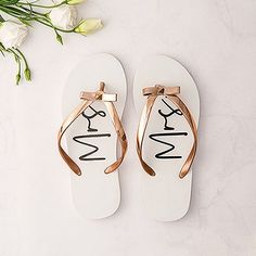 a pair of white and gold sandals with the word mr and mrs written on them