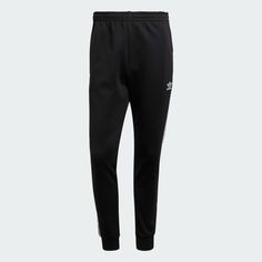 adidas Adicolor Classics SST Track Pants - Black | Men's Lifestyle | adidas US Athleisure Jogging Bottoms With Three Stripes Branding, Athleisure Jogging Bottoms With Three Stripes, Athleisure Bottoms With Three Stripes For Jogging, Adidas Athleisure Pants With Logo, Adidas Athleisure Bottoms With Three Stripes, Adidas Relaxed Fit Sweatpants With Three Stripes, Adidas Sportswear Pants With Three Stripes, Adidas Bottoms With Side Stripes For Jogging, Adidas Jogging Bottoms With Side Stripes