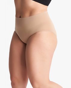 These hip-hugging briefs are crafted from a compression material that gives you an all-day held-in feeling. Their seamless construction makes them ideal to wear under denim, trousers, and skirts alike. These plus-size shapewear briefs are as supportive as they are stylish. Yummie Seamless Brief | Brown | Intimates | Materials & Care Instructions: 81% Nylon, 19% Spandex, Hand wash Compressive Shapewear Bottoms With Built-in Bra, Elegant Supportive Solid Bottoms, Supportive Solid Color Shapewear Bottoms, Elegant Supportive Solid Color Bottoms, Elegant Soft Touch Brief Shapewear, Supportive Shapewear Made Of Elastane, Elegant No-show Micro-elastic Shapewear, Supportive Solid Color Smoothing Bottoms, Supportive Solid Shapewear In Elastane